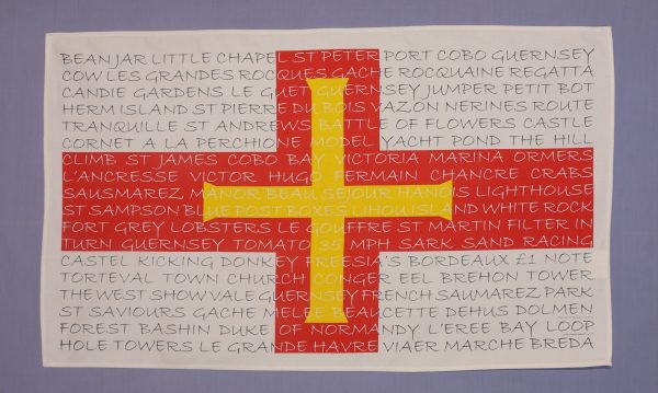 TEATOWEL FLAG WITH GUERNSEY TEXT OVERLAYED